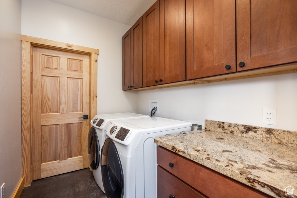 Laundry area with cabinet space and washing machine and dryer