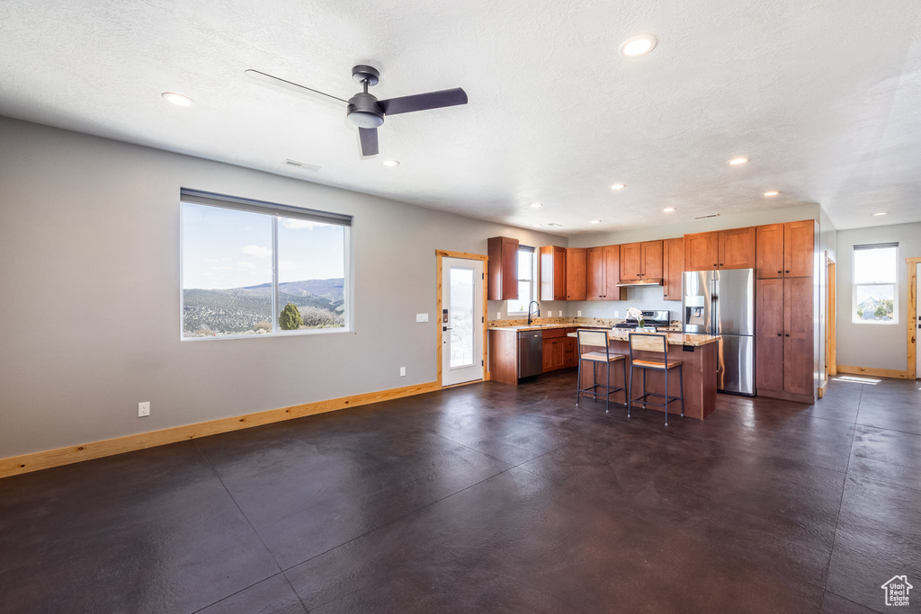 Kitchen featuring stainless steel appliances, baseboards, recessed lighting, and healthy amount of natural light