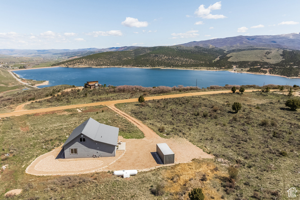 View from above of property with a water and mountain view