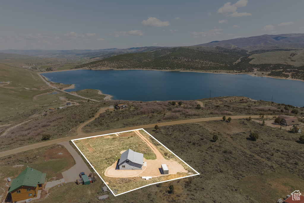 View of property location featuring a water and mountain view and property parcel outlined