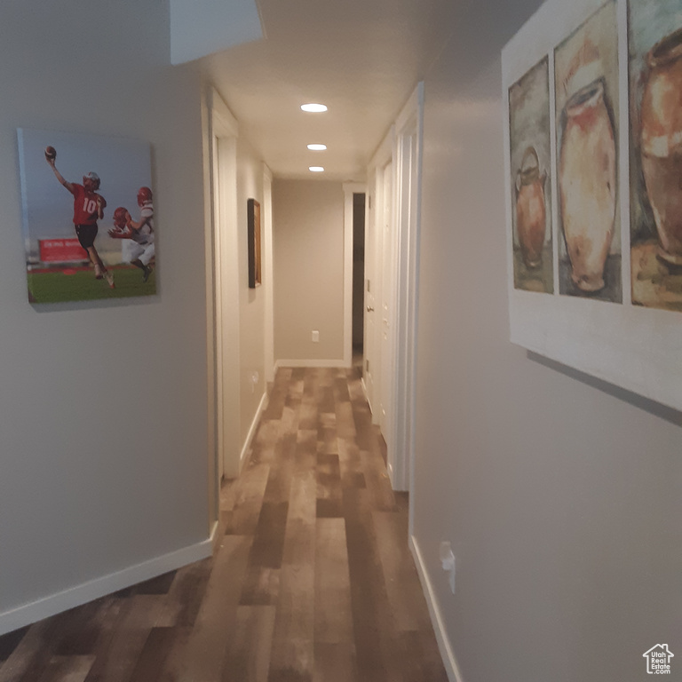 Hallway with wood finished floors, recessed lighting, and baseboards