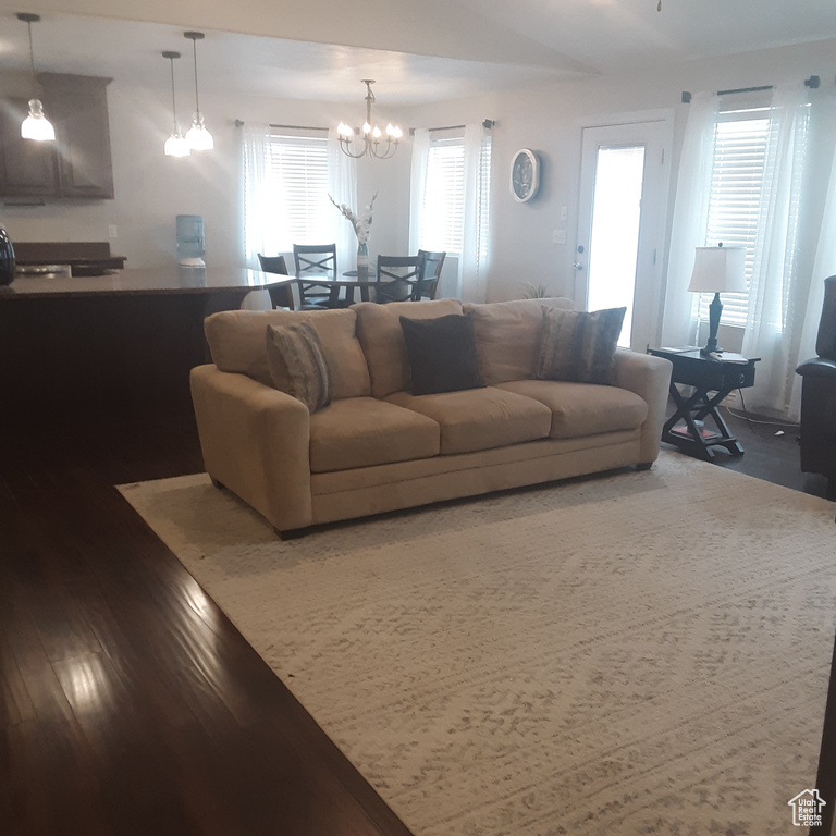 Living room featuring a chandelier and wood finished floors