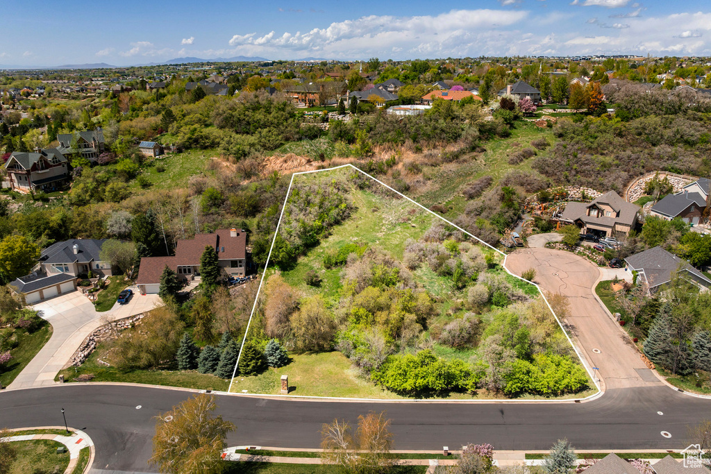 Aerial view of residential area featuring property boundaries highlighted