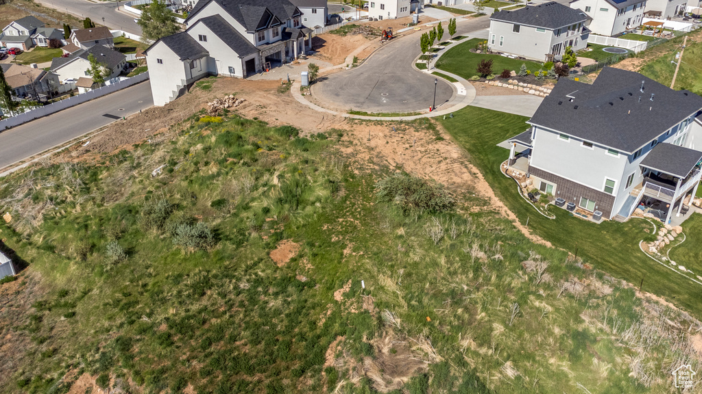 Aerial view of property and surrounding area with nearby suburban area