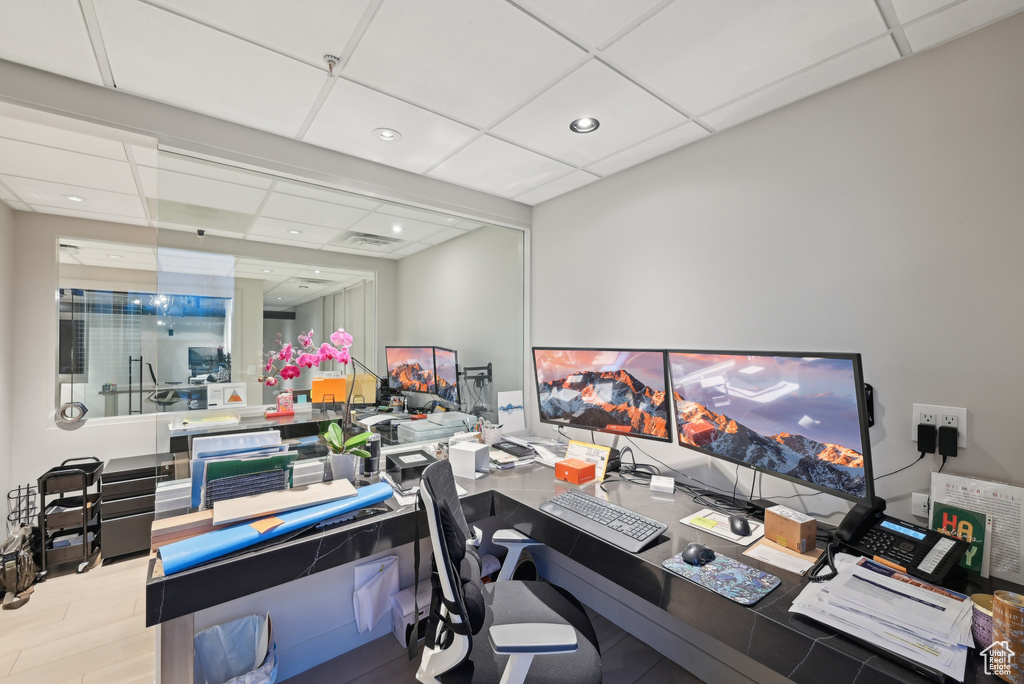 Office area with a paneled ceiling, recessed lighting, and wood finished floors