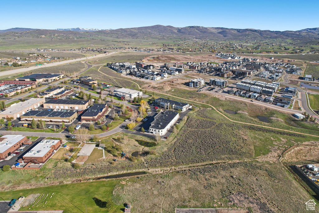 Aerial view of property's location with a mountain backdrop