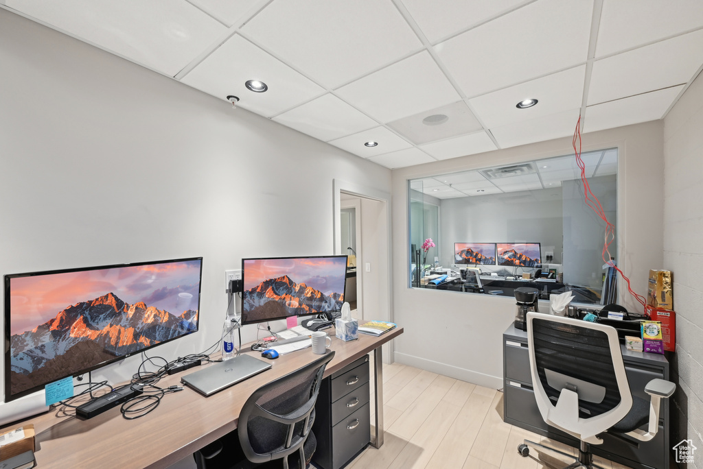 Office with a drop ceiling, recessed lighting, and baseboards