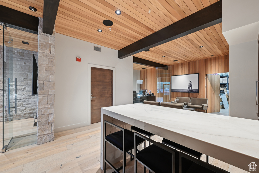 Kitchen with wooden ceiling, beamed ceiling, wood finished floors, recessed lighting, and baseboards