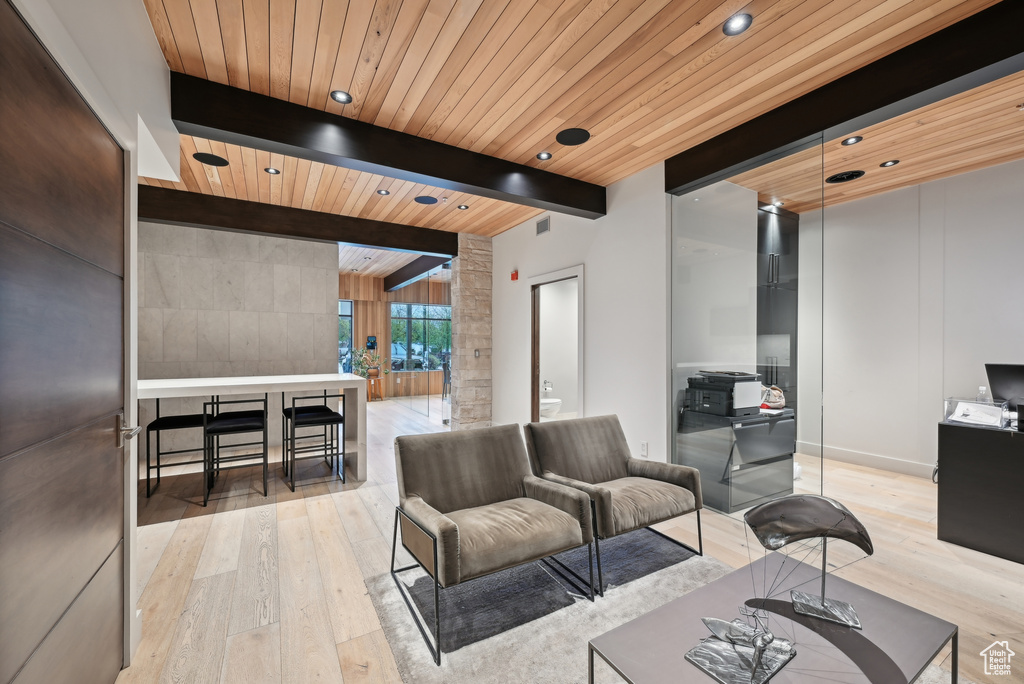 Living area featuring light wood-type flooring, wooden ceiling, and recessed lighting