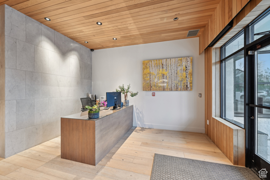 Reception with recessed lighting and wooden ceiling