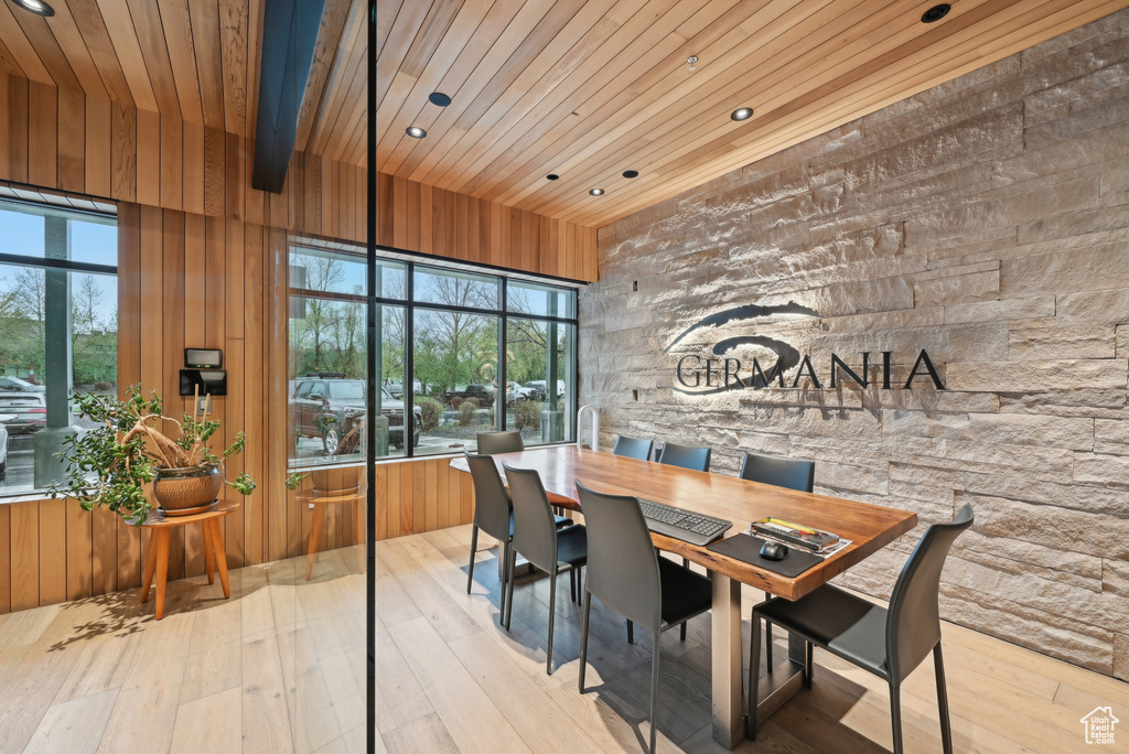 Dining space featuring wood ceiling, wooden walls, recessed lighting, and wood-type flooring