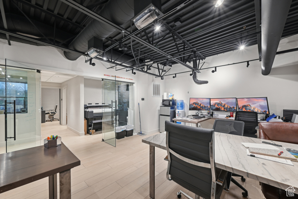 Office with wood finished floors and baseboards