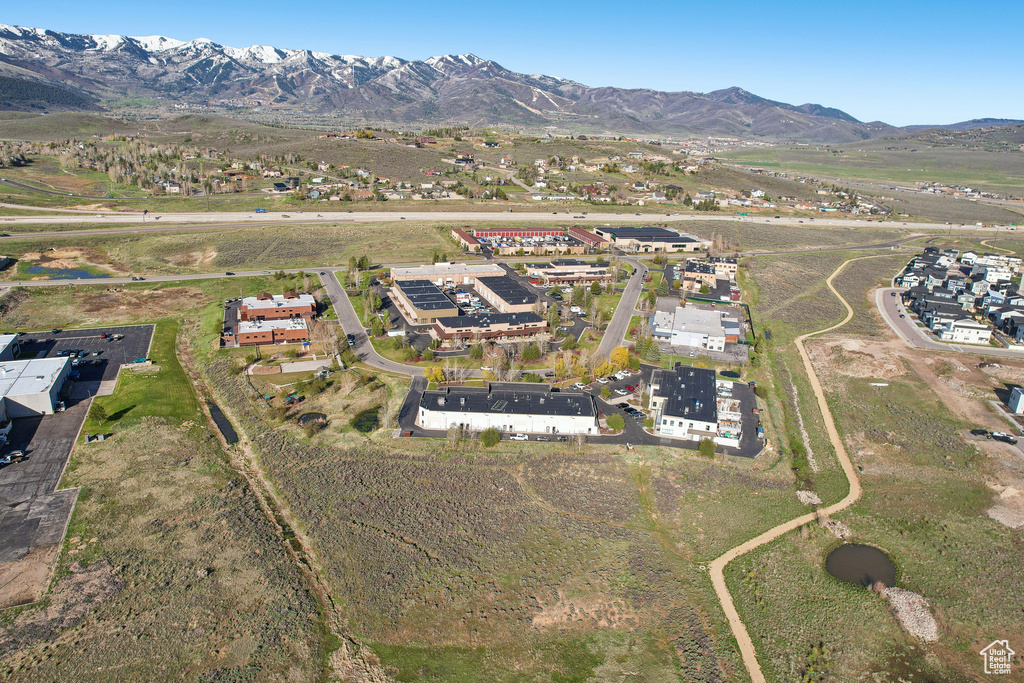 Aerial view of property's location featuring a mountainous background