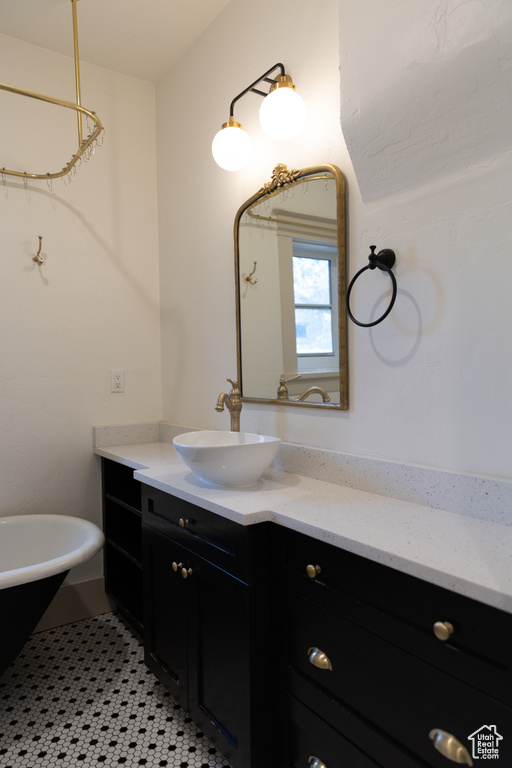 Full bath with vanity and a soaking tub