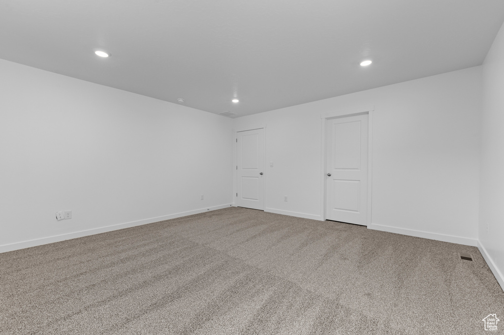 Spare room featuring recessed lighting, carpet, and baseboards