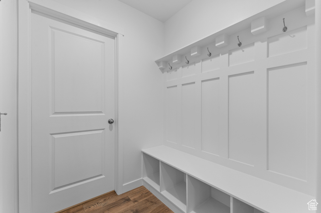 Mudroom with dark wood-style floors and baseboards