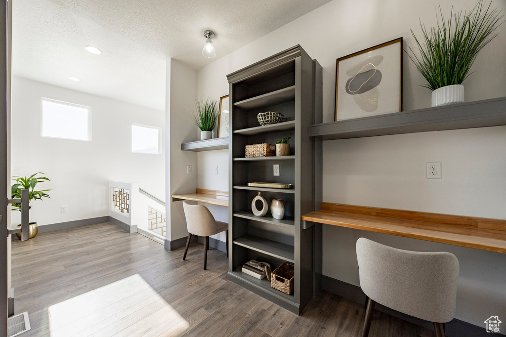 Office area with baseboards, wood finished floors, and recessed lighting