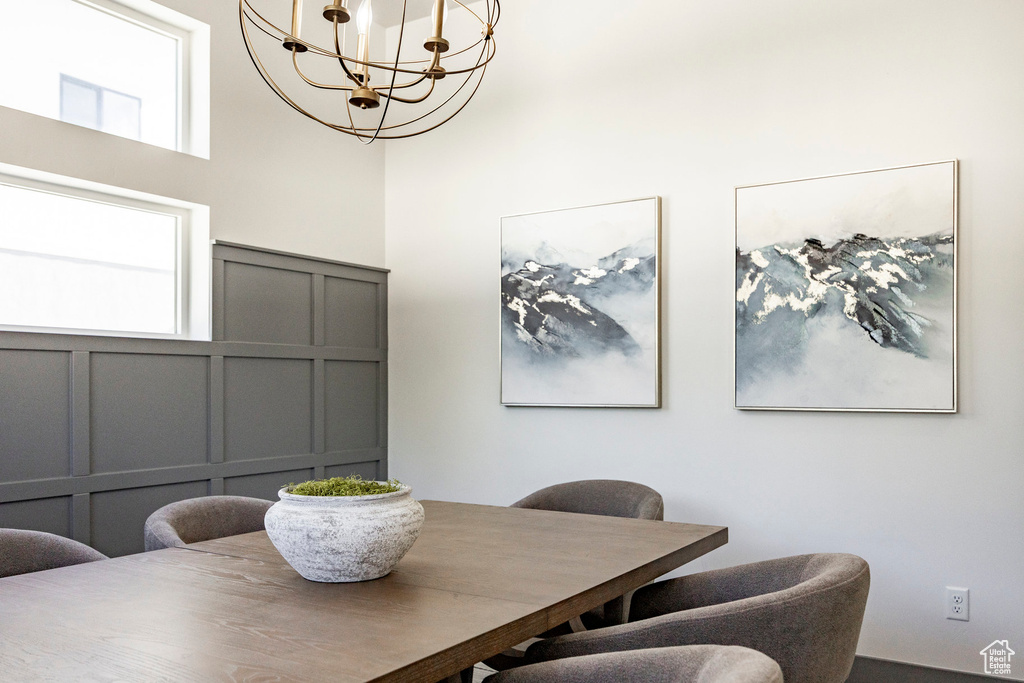 Dining area with a decorative wall and a chandelier