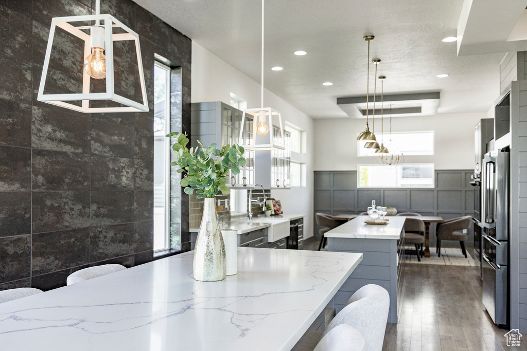 Kitchen featuring a kitchen island, dark wood finished floors, plenty of natural light, recessed lighting, and pendant lighting