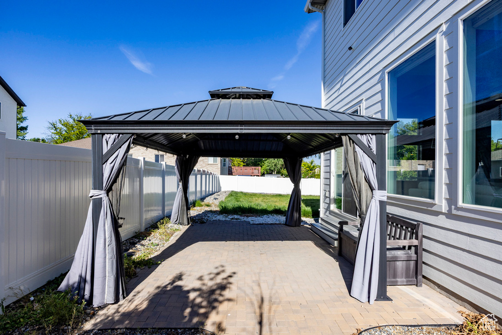 View of patio featuring a gazebo and a fenced backyard