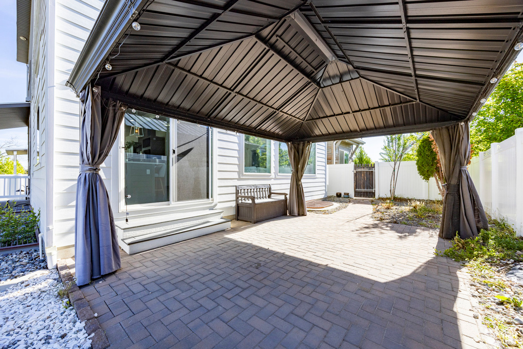 View of patio / terrace featuring entry steps, fence, and a gazebo