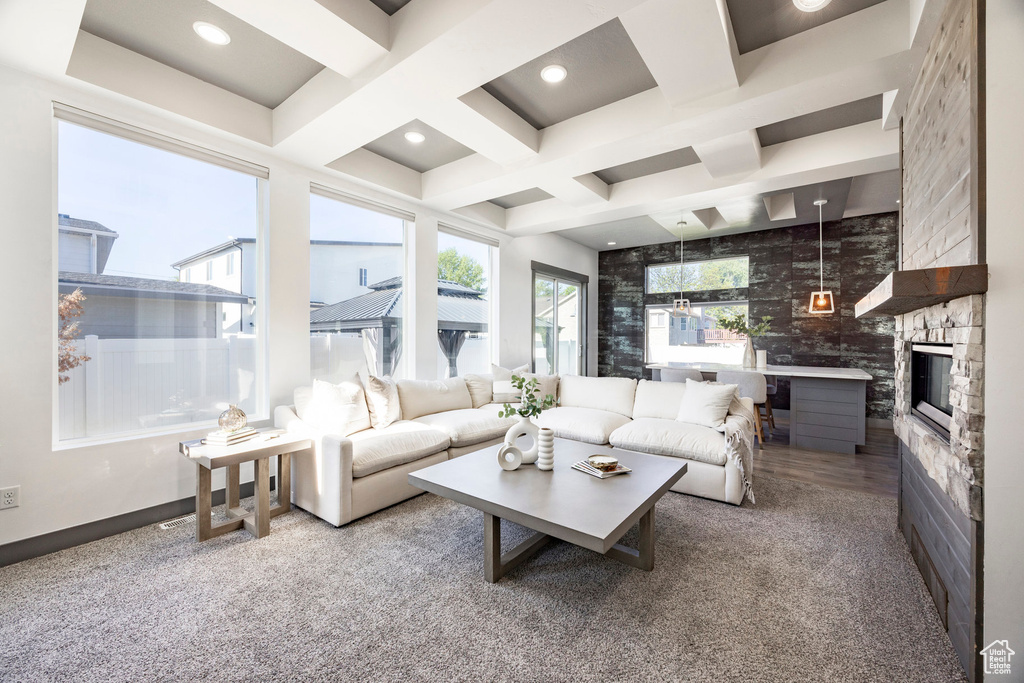 Living area featuring coffered ceiling, a fireplace, beamed ceiling, and recessed lighting