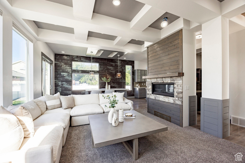 Living area featuring coffered ceiling, a fireplace, beam ceiling, wood finished floors, and recessed lighting