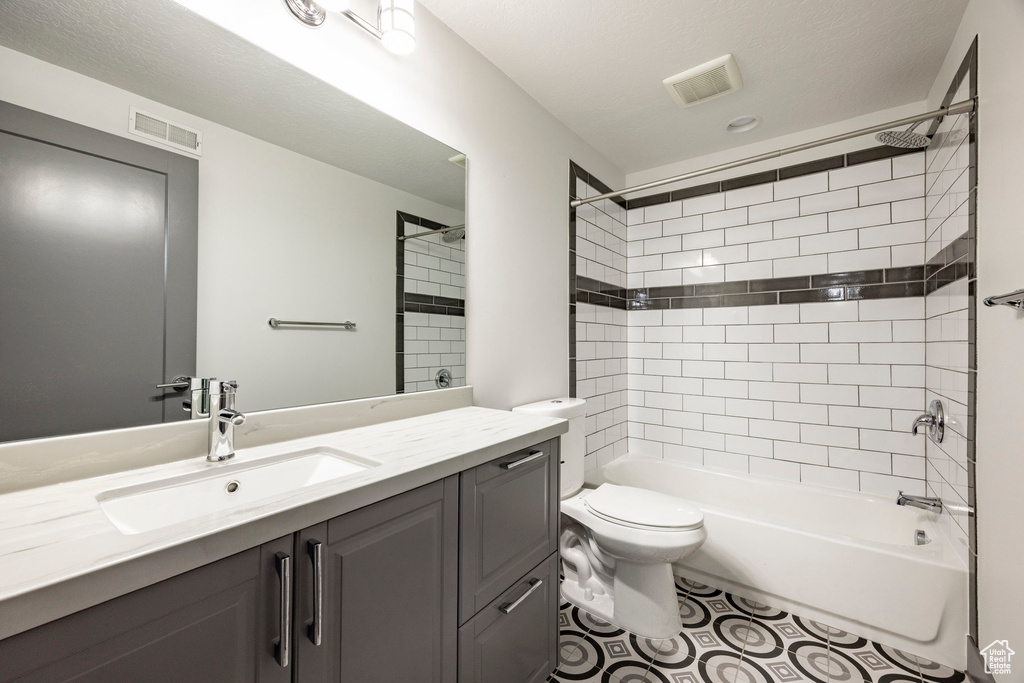 Full bath with toilet, vanity, and tub / shower combination