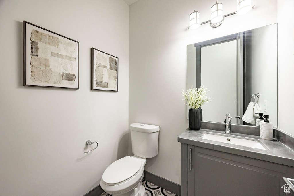 Half bath featuring toilet and vanity