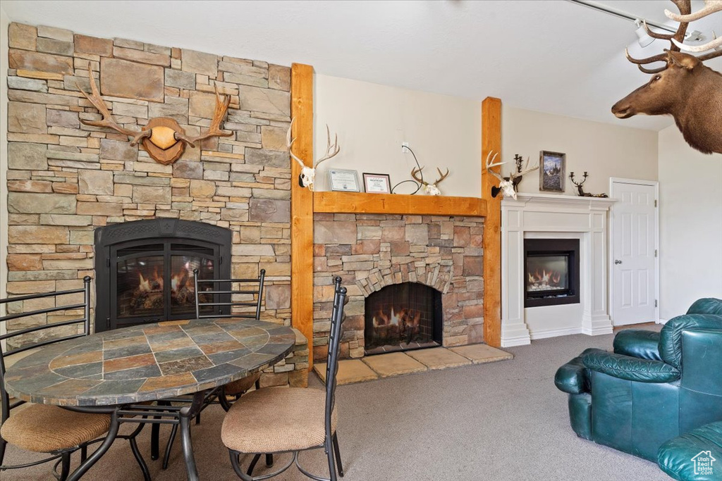 Living room with a fireplace and carpet floors