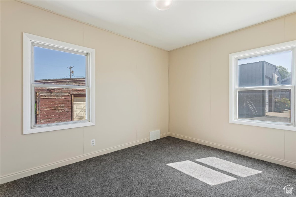 Unfurnished room featuring carpet floors and baseboards