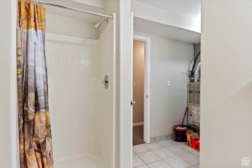 Bathroom featuring a stall shower and tile patterned flooring
