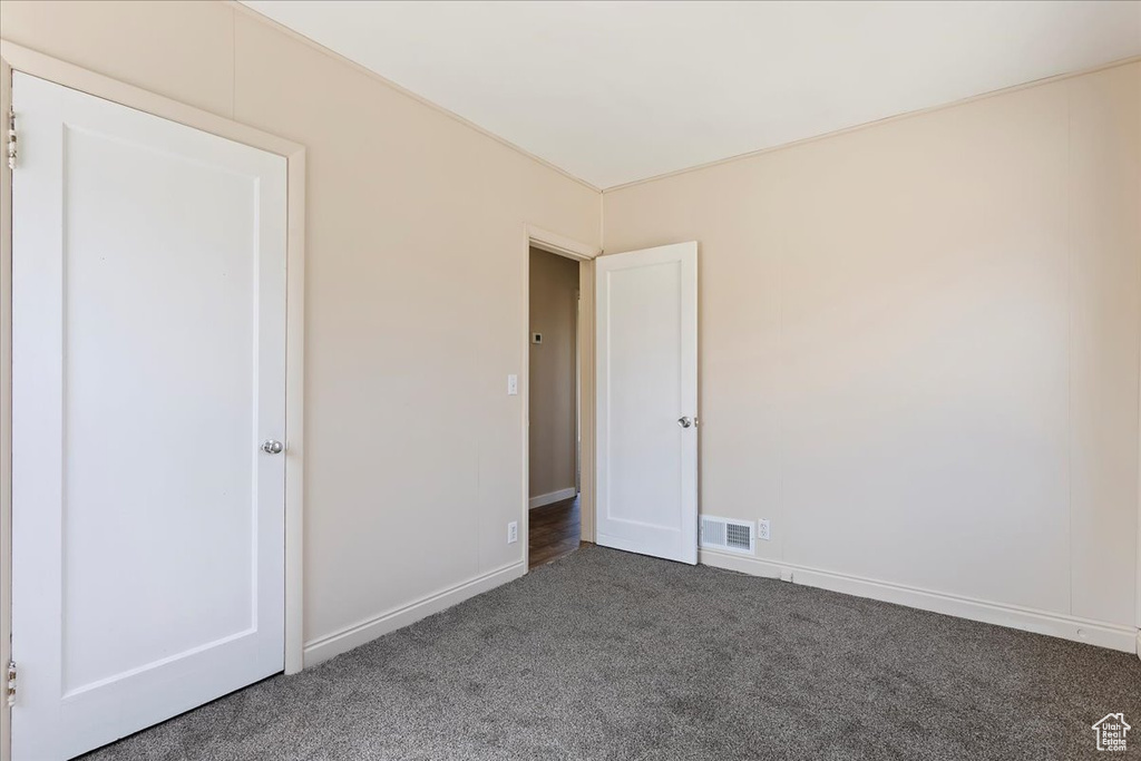 Unfurnished bedroom featuring carpet floors and baseboards