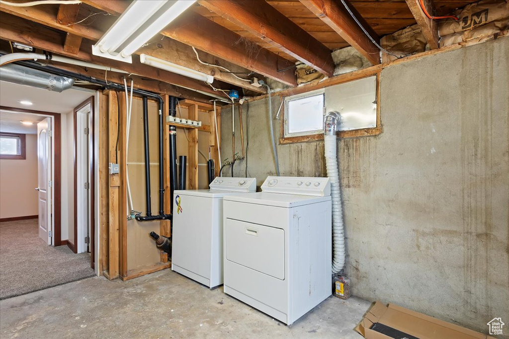 Laundry room with washing machine and clothes dryer