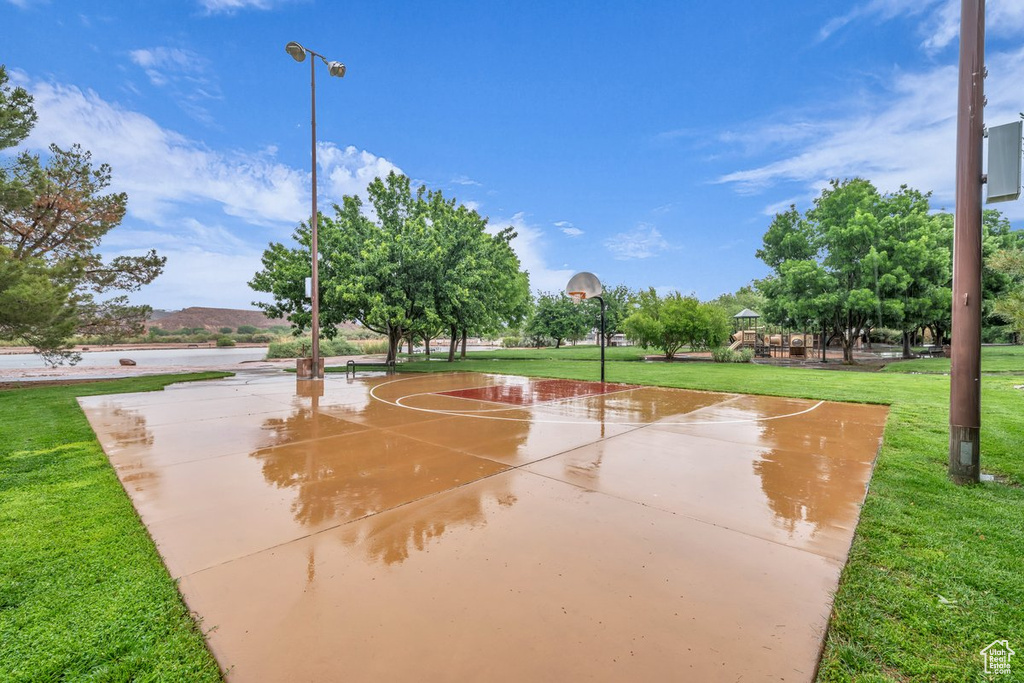 View of sport court featuring community basketball court and a lawn