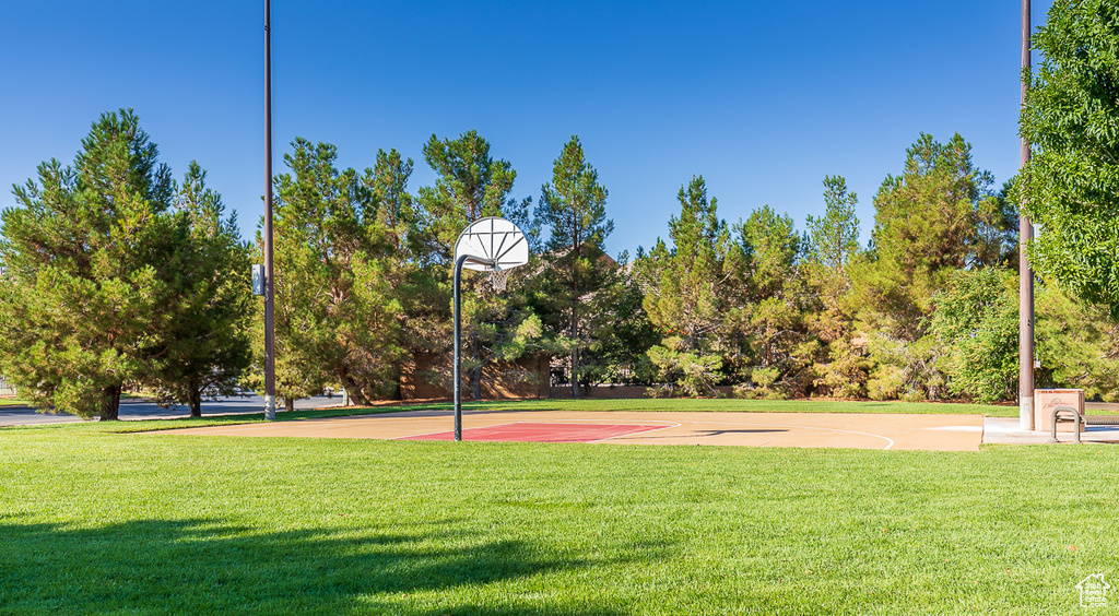 View of sport court featuring a lawn and community basketball court