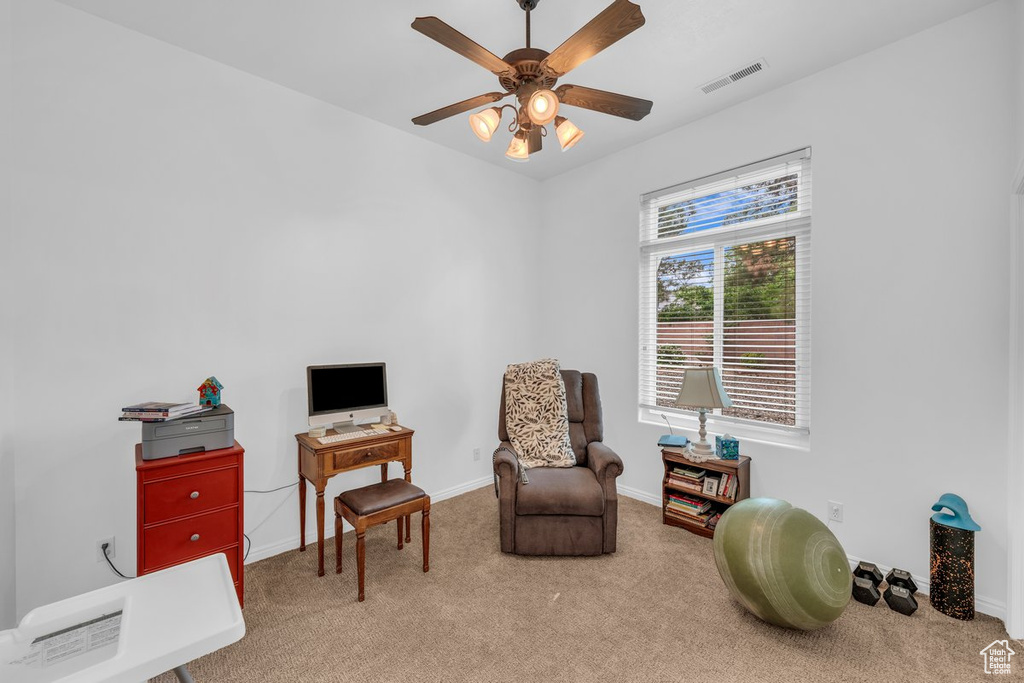 Sitting room with carpet flooring, a ceiling fan, and baseboards