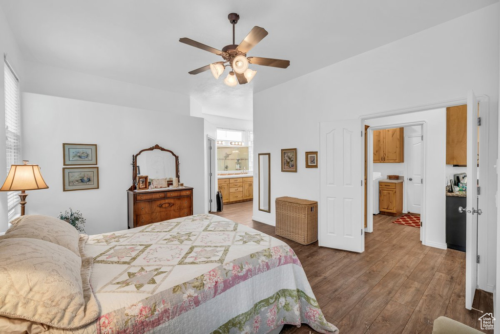 Bedroom featuring wood finished floors, connected bathroom, and ceiling fan