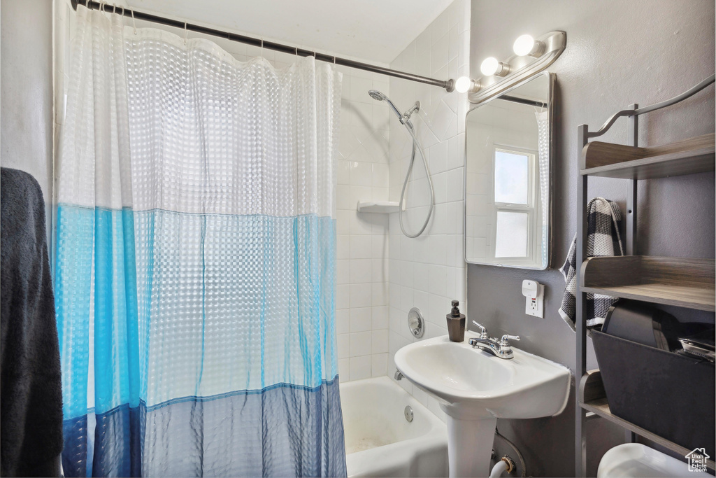Bathroom featuring shower / tub combo and a sink