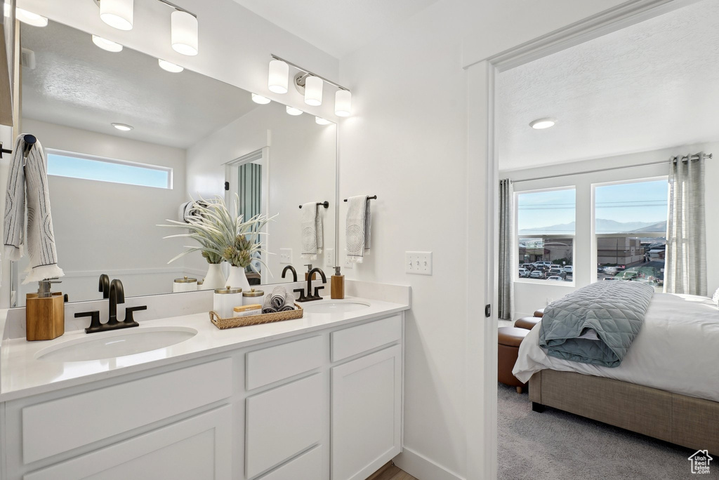 Ensuite bathroom featuring double vanity