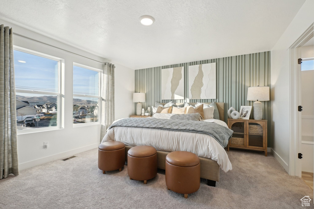 Bedroom featuring baseboards and carpet