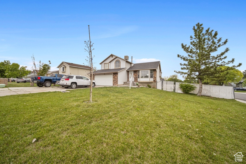 View of front of property with concrete driveway