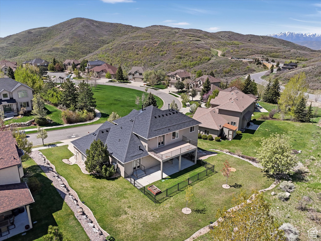 Aerial overview of property\\\'s location with nearby suburban area and a mountain backdrop