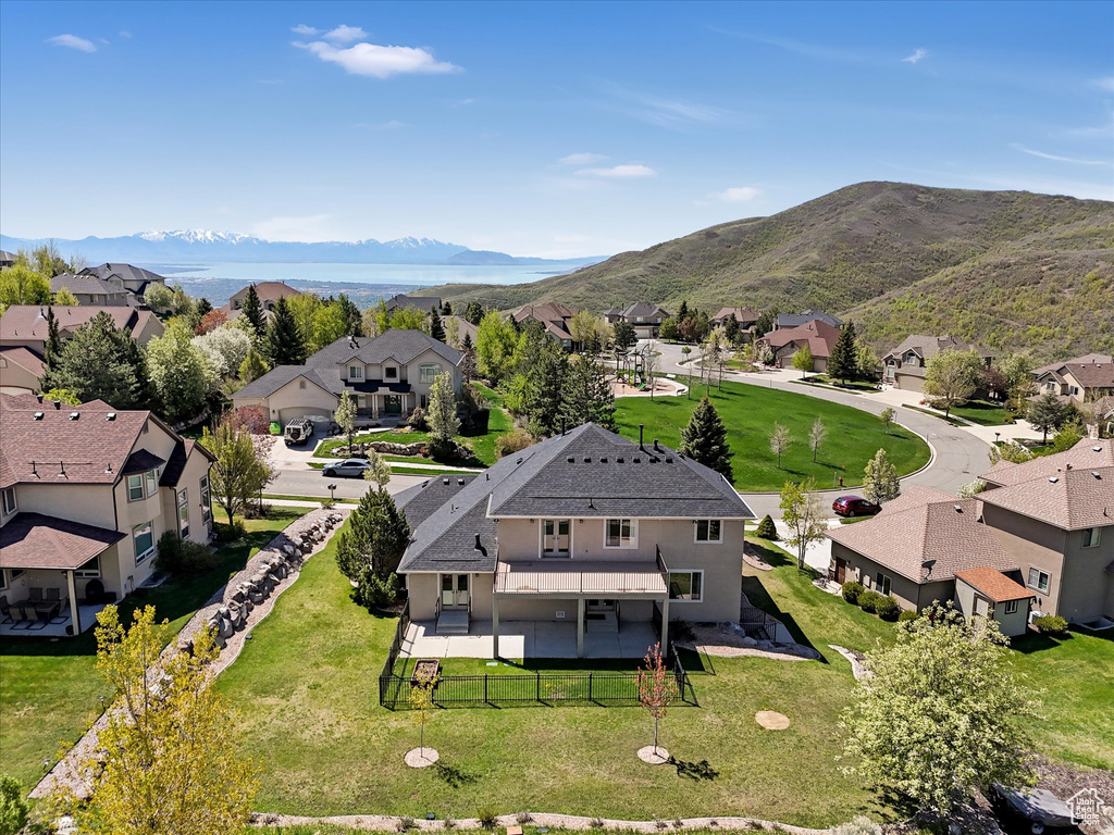Aerial view of residential area featuring a mountainous background