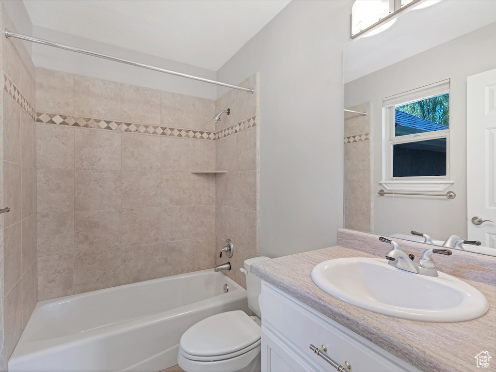 Full bathroom featuring vanity,  shower combination, and toilet
