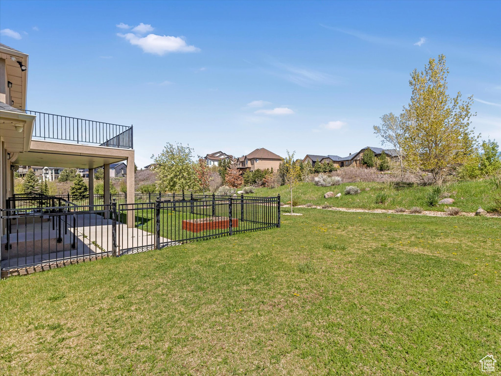 View of yard with a balcony and a patio area
