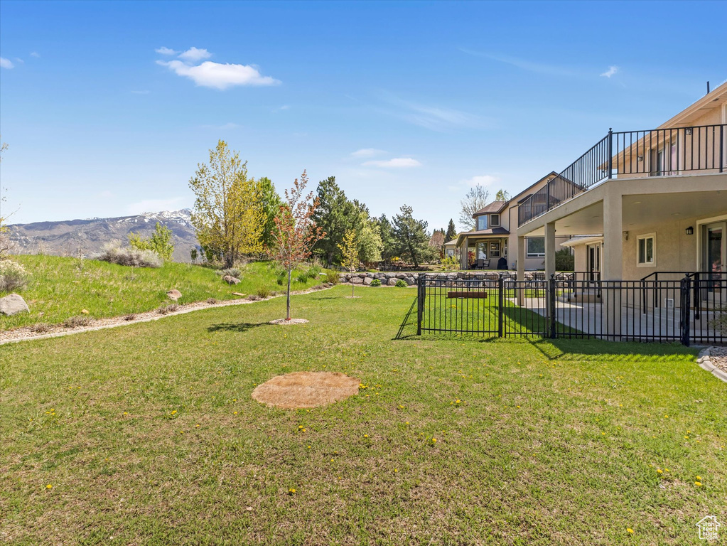 View of yard featuring a balcony and a patio area