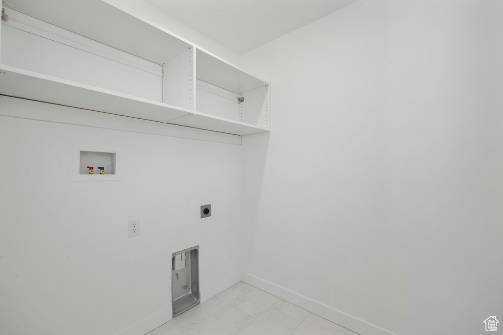 Laundry area featuring hookup for a washing machine, light marble finish flooring, baseboards, and electric dryer hookup