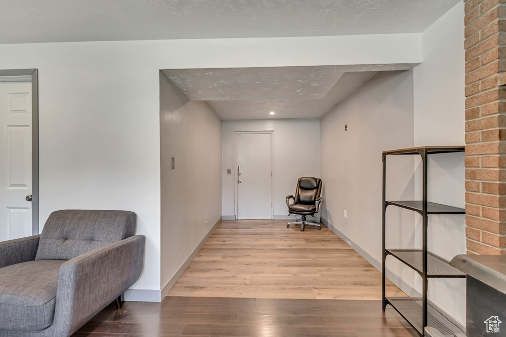Sitting room with wood finished floors and baseboards