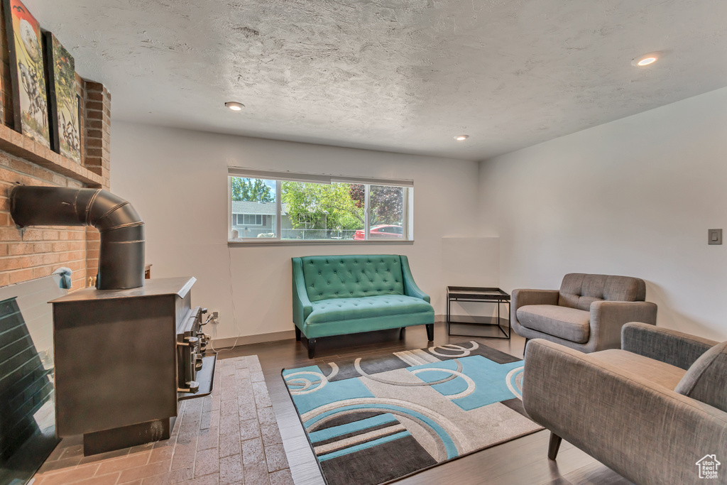 Living area featuring a wood stove, recessed lighting, and baseboards